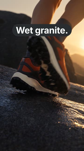 A vertical ad: a runner’s burnt orange trail shoe landing on wet dark granite at golden hour, with the words “Wet granite.”